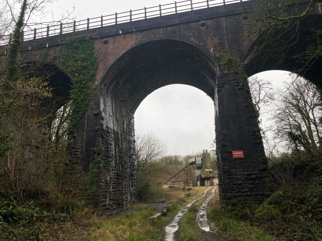 a 100ft high viaduct over a muddy track