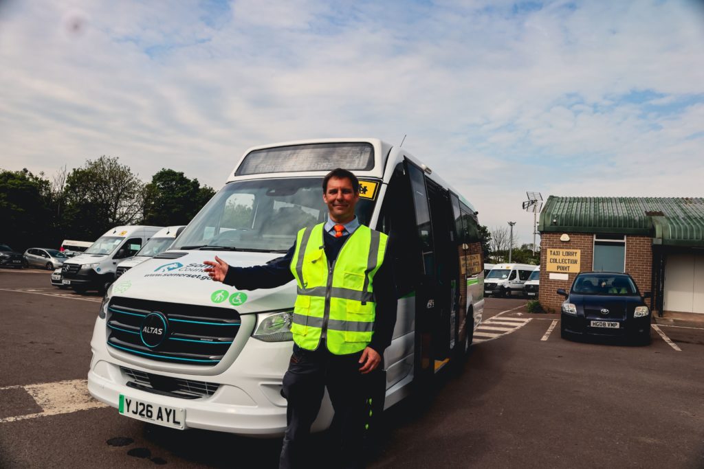 Councillor Richard Wilkins points to the new electric minibus in Frome