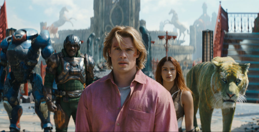 Characters from Masters of the Universe walk through a fantasy city set, including armoured figures and a large green tiger.