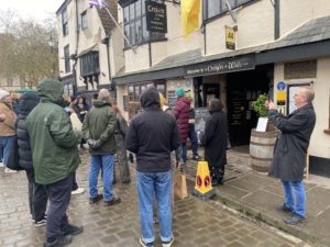 A crowd of people assembled outside The Crown pub in Wells.