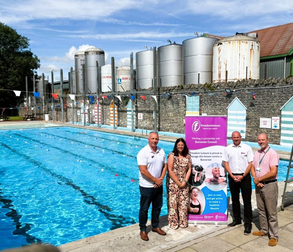 Cllr Federica Smith-Roberts, Somerset Council and Freedom Leisure staff stand beside Shepton Mallet Lido following leisure service agreement.