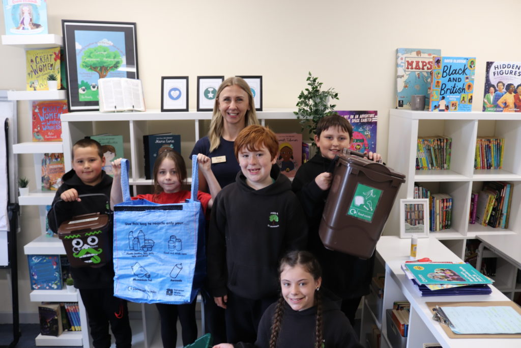 Teacher and five pupils at Priddy and St Lawrence School with recycling containers during a Schools Against Waste visit.