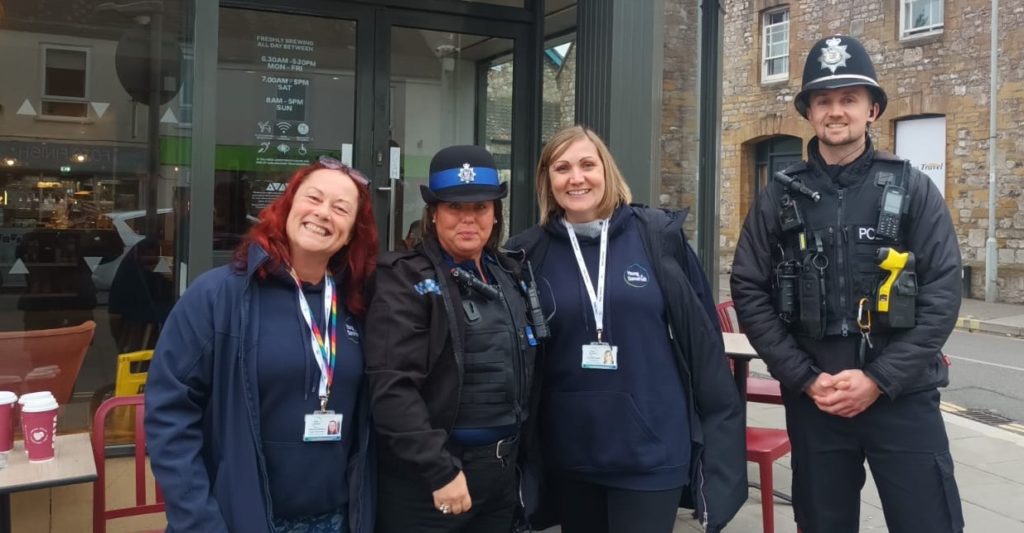 Youth Hub staff and AS Police officers standing in a row outside a youth hub in Taunton.