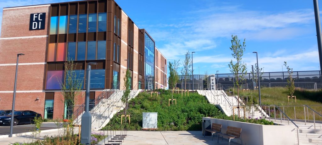Firepool site in Taunton with the FCDI building, landscaped steps and public realm improvements beside development land.
