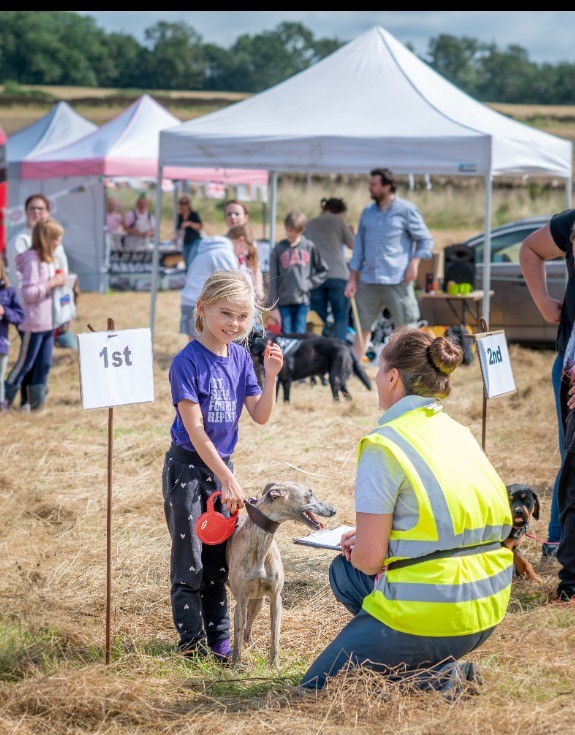 Young girl claiming her prize with her dog at Ham Hill Dog Show