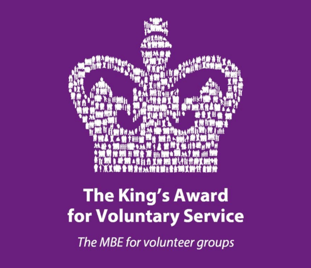 King’s Award for Voluntary Service logo featuring a crown formed from people on a purple background.