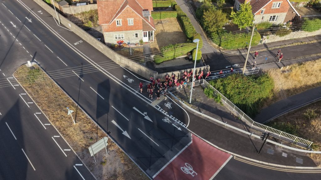Aerial view of a road junction with segregated cycle lanes, pedestrian routes and nearby homes in Somerset.