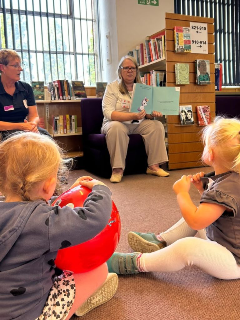 Children being read to in a library.
